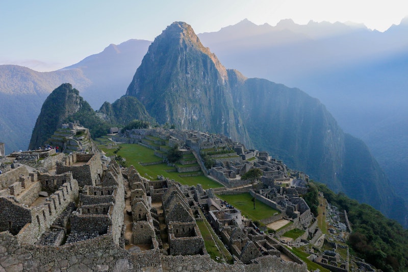 Machu Picchu about to be empty, the last visitors leave the citadel as the night begins to fade the day out.