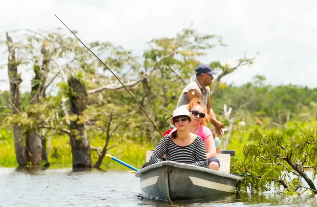 A touristic boat sails around a Amazon body of water